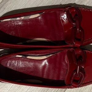 Women’s Burberry London red patent leather red loafer featuring a chain detail